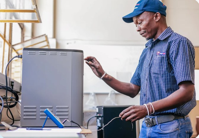 A Top Coolers technician installing a plumbed-in water cooler